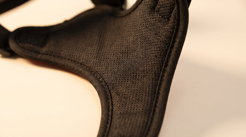 Close crop of the breathable mesh lining and stitched edge binding on the inside of a black personalised dog harness.